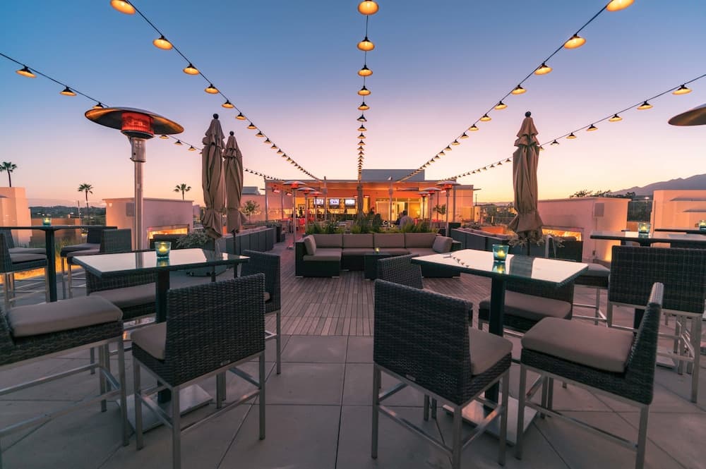 Hilton Garden Inn Santa Barbara Goleta rooftop lounge with string lights at dusk