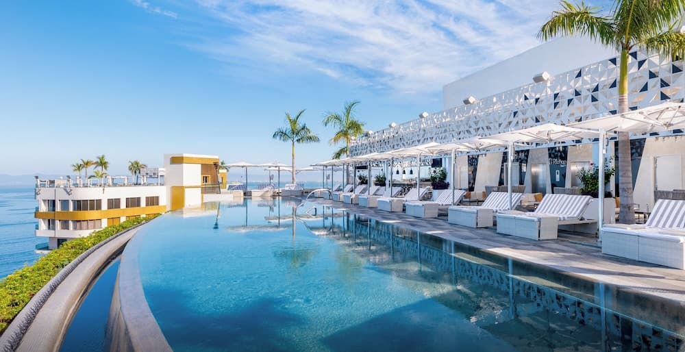 Luxury suite interior at Hotel Mousai with gold accents and Pacific views