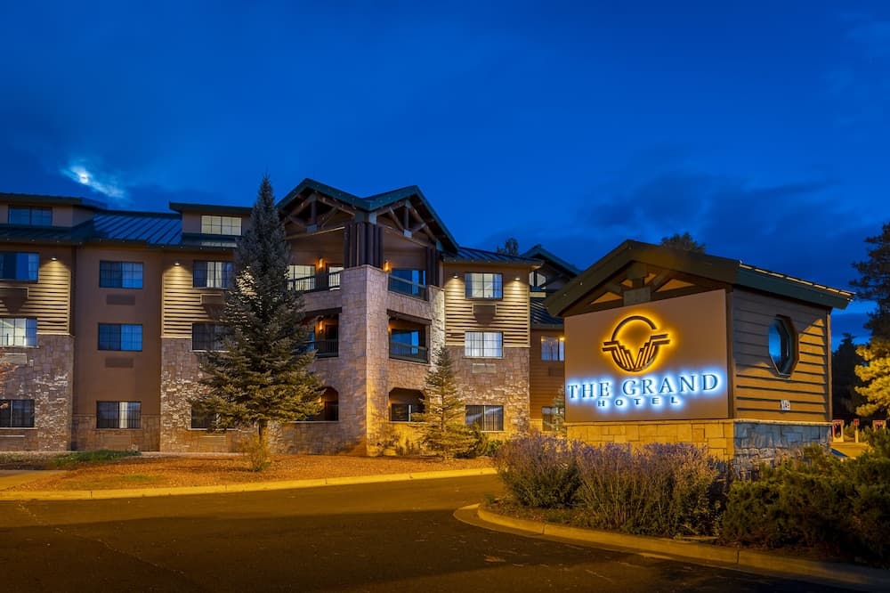 The Grand Hotel at the Grand Canyon exterior framed by ponderosa pines in Tusayan, Arizona